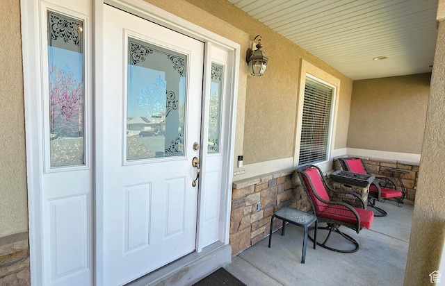 6723 W Hunter Farm Cir S, West Valley City, UT 84128 - property entrance with stucco siding, covered porch, and stone siding