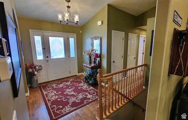 6723 W Hunter Farm Cir S, West Valley City, UT 84128 - entryway featuring a chandelier, wood finished floors, vaulted ceiling, and baseboards