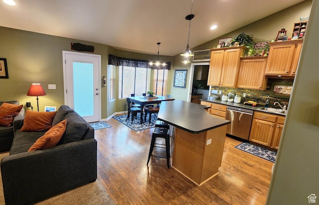 6723 W Hunter Farm Cir S, West Valley City, UT 84128 - kitchen with stainless steel dishwasher, dark countertops, open floor plan, a chandelier, and wood finished floors