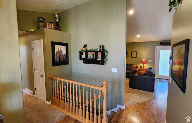 6723 W Hunter Farm Cir S, West Valley City, UT 84128 - corridor featuring an upstairs landing, wood finished floors, baseboards, and recessed lighting