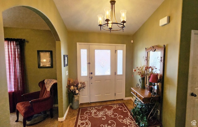 6723 W Hunter Farm Cir S, West Valley City, UT 84128 - foyer entrance with arched walkways, a chandelier, wood finished floors, vaulted ceiling, and baseboards