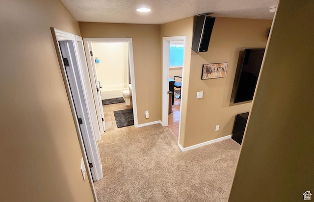 6723 W Hunter Farm Cir S, West Valley City, UT 84128 - hallway with light carpet, baseboards, and a textured ceiling