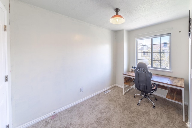 home office with baseboards, carpet flooring, a textured ceiling, and visible vents