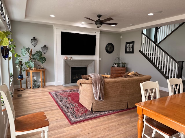 living room with ceiling fan, recessed lighting, and light wood-style floors