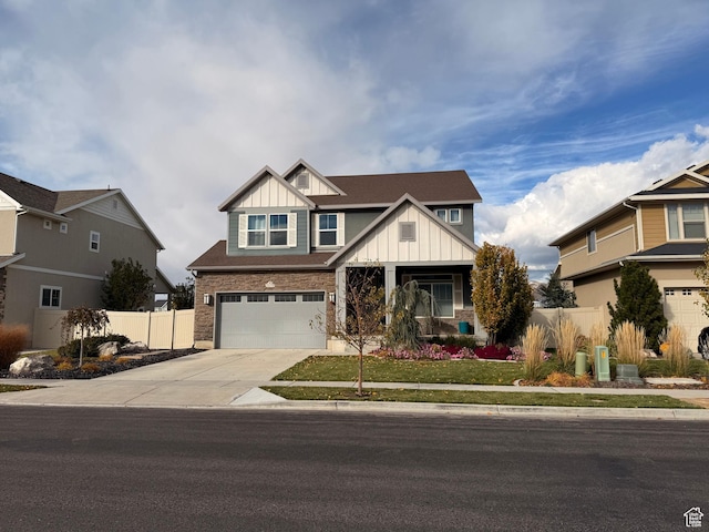 craftsman-style house featuring board and batten siding, driveway, a garage, and fence