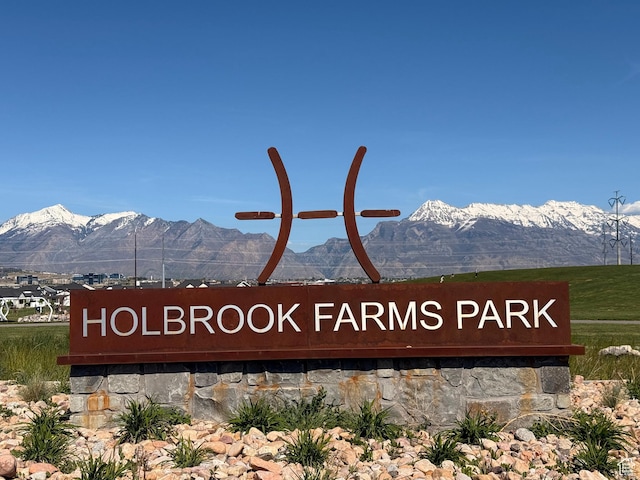 community / neighborhood sign with a mountain view