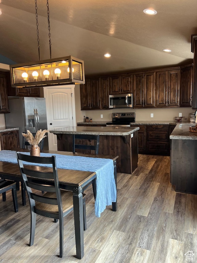 247 N 300 E, Fairview, UT 84629 - kitchen featuring recessed lighting, wood finished floors, a kitchen island, dark brown cabinetry, and appliances with stainless steel finishes