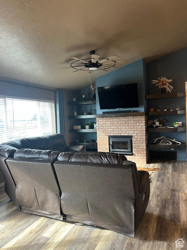247 N 300 E, Fairview, UT 84629 - living area featuring a textured ceiling, wood finished floors, a brick fireplace, and a ceiling fan