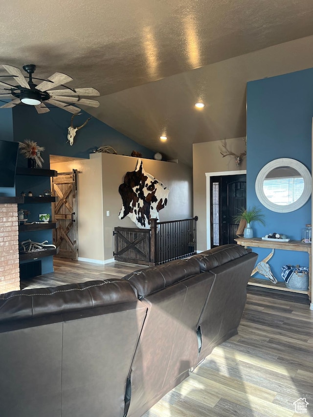 247 N 300 E, Fairview, UT 84629 - living area with a barn door, vaulted ceiling, wood finished floors, a textured ceiling, and ceiling fan