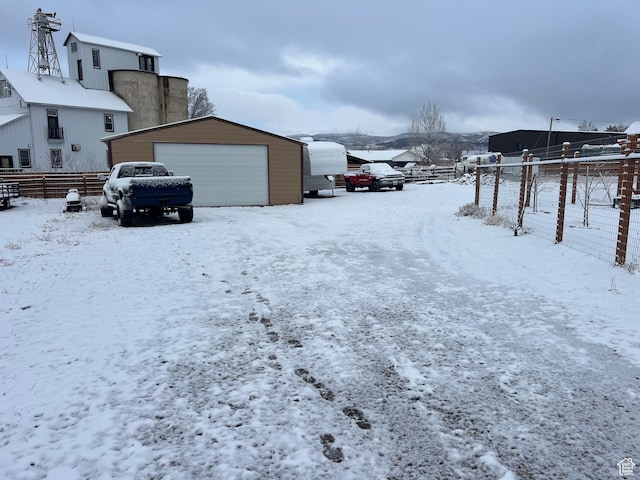247 N 300 E, Fairview, UT 84629 - snowy yard featuring a garage, fence, and an outdoor structure