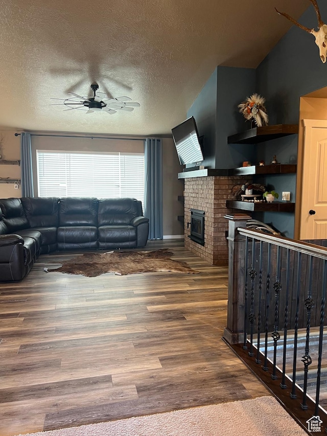 247 N 300 E, Fairview, UT 84629 - living room featuring a ceiling fan, wood finished floors, a textured ceiling, and a fireplace