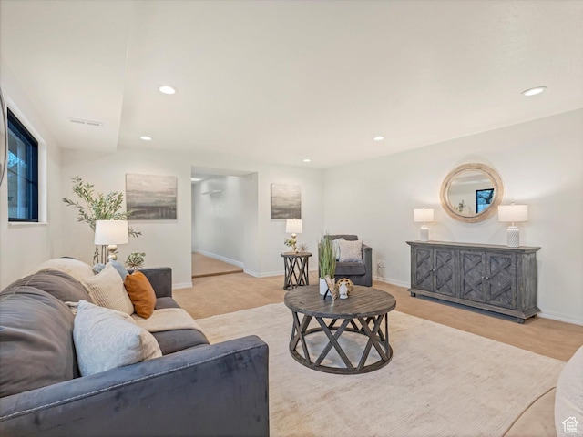 living room featuring recessed lighting, visible vents, and baseboards