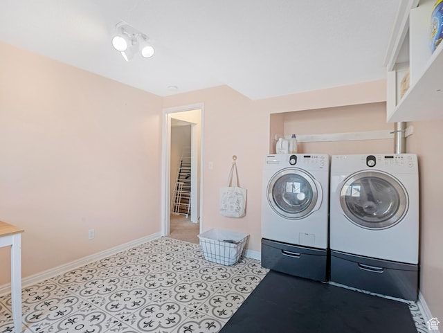 laundry area with washing machine and clothes dryer, baseboards, laundry area, and light tile patterned floors