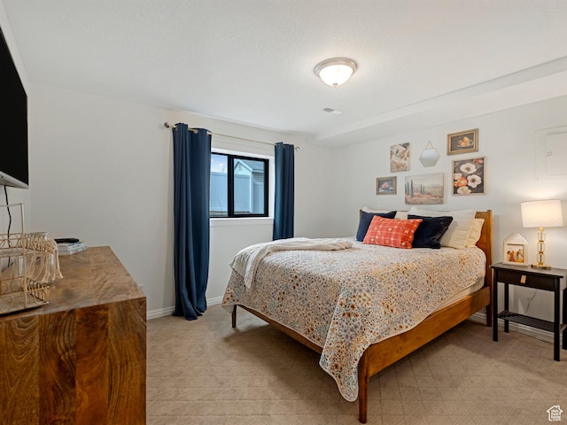 bedroom featuring baseboards, visible vents, and light colored carpet