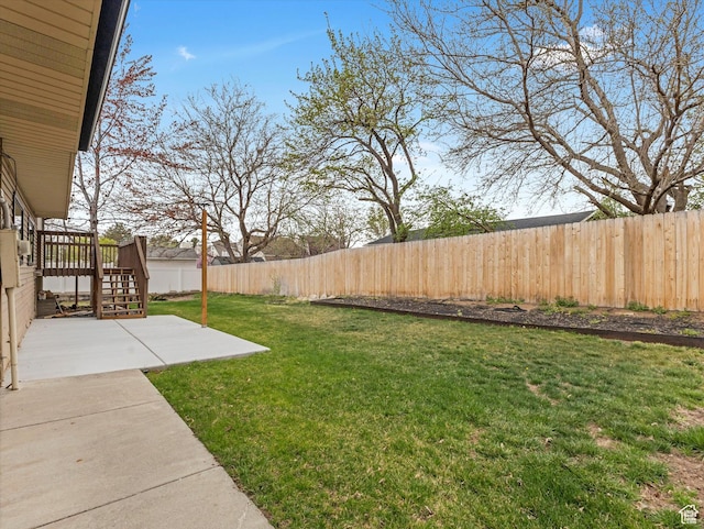 view of yard with a wooden deck, a patio, a fenced backyard, and stairway