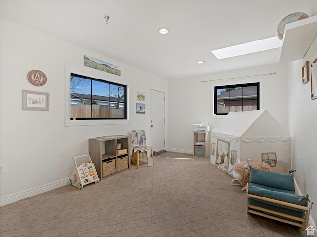 playroom with recessed lighting, baseboards, carpet flooring, and a skylight