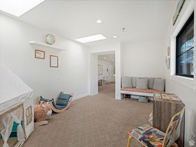 sitting room featuring recessed lighting, carpet floors, a skylight, and baseboards
