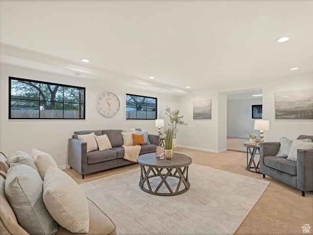 living area featuring light carpet, baseboards, and recessed lighting