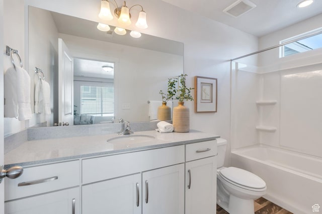 ensuite bathroom featuring plenty of natural light, visible vents, toilet, and vanity