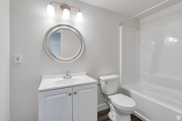 bathroom featuring  shower combination, toilet, baseboards, wood finished floors, and vanity