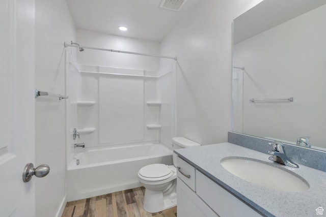bathroom featuring wood finished floors, visible vents, toilet, vanity, and shower / tub combination