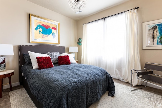 bedroom featuring baseboards and carpet