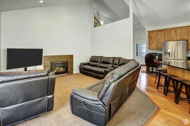 10716 N Hayes Cir, Cedar Hills, UT 84062 - living area featuring light wood-type flooring, recessed lighting, a tiled fireplace, and high vaulted ceiling