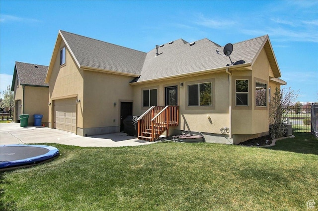10716 N Hayes Cir, Cedar Hills, UT 84062 - back of house featuring stucco siding, a garage, a lawn, and fence
