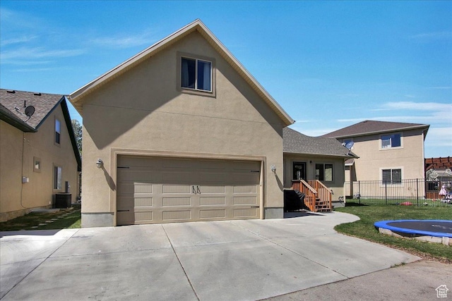 10716 N Hayes Cir, Cedar Hills, UT 84062 - view of front of home featuring fence, a garage, stucco siding, central air condition unit, and driveway