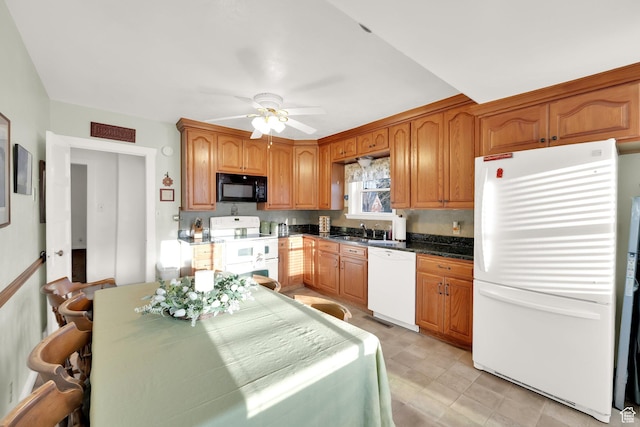 kitchen featuring brown cabinets, a ceiling fan, a sink, and white appliances