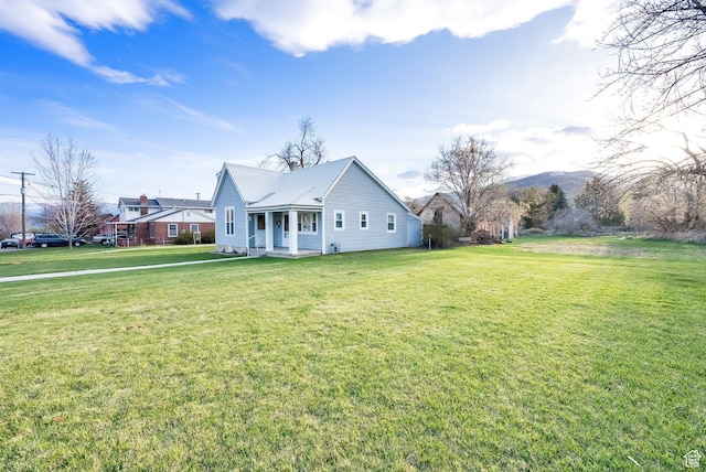 view of front facade featuring a porch, a front lawn, and metal roof
