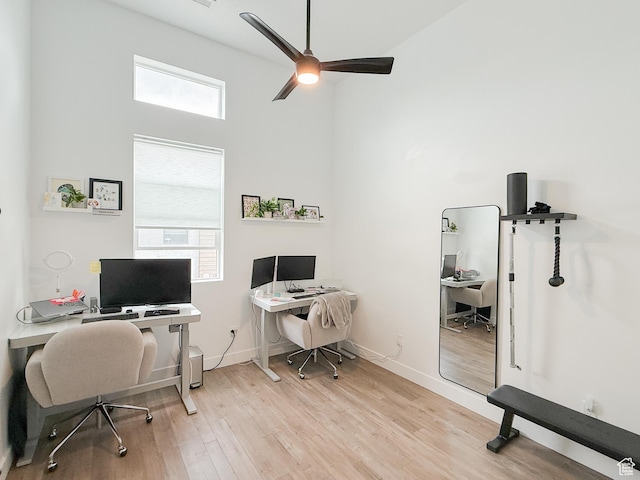 office featuring baseboards, a ceiling fan, and wood finished floors