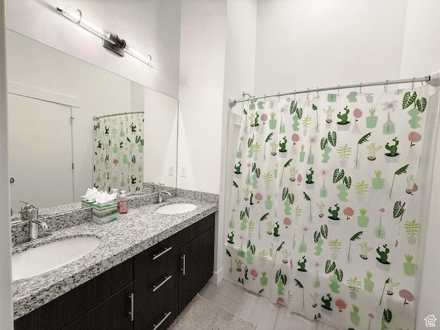 bathroom with a sink, double vanity, and curtained shower