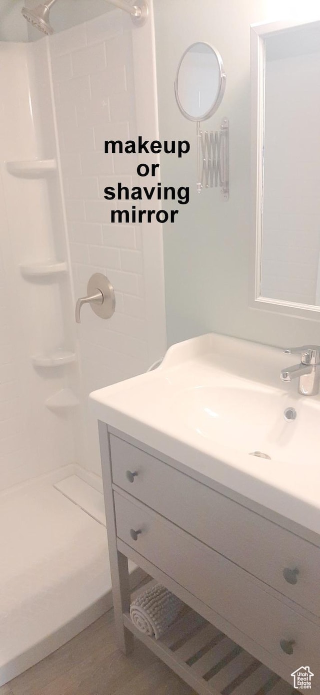 338 E 100 N, Moab, UT 84532 - bathroom featuring walk in shower, vanity, and wood finished floors