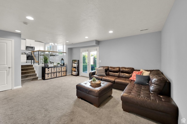 carpeted living area featuring stairs, visible vents, and recessed lighting
