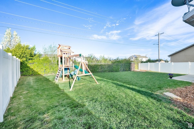 view of yard featuring a fenced backyard and a playground