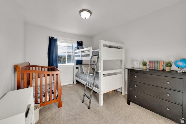 bedroom with light carpet and baseboards