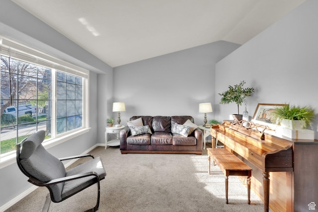 carpeted living area with lofted ceiling, a wealth of natural light, and baseboards