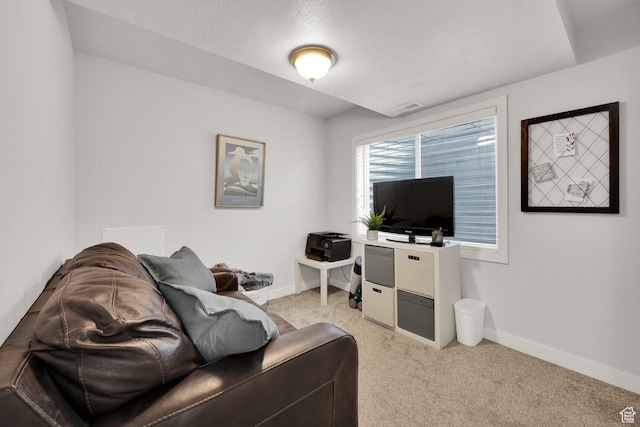 living area with visible vents, baseboards, and light carpet