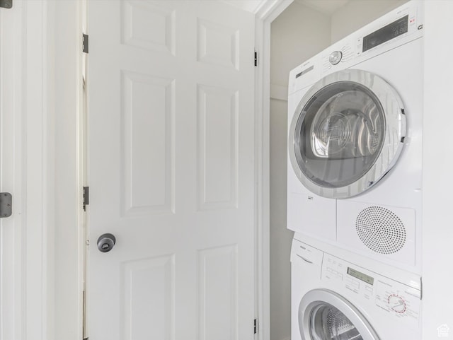 washroom with stacked washer / dryer and laundry area