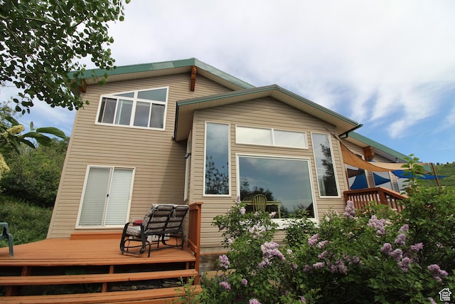 back of property with a wooden deck
