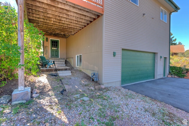 view of property exterior featuring driveway and a garage