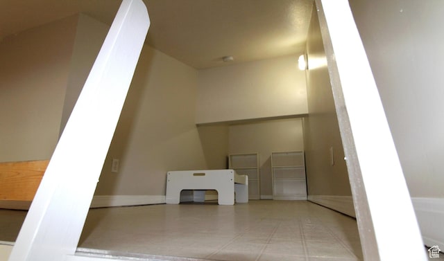 interior space with baseboards and light tile patterned floors
