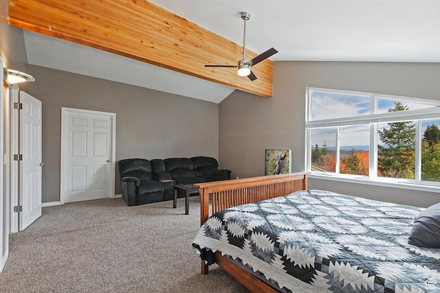 carpeted bedroom with lofted ceiling, baseboards, and ceiling fan