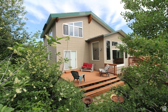 rear view of property featuring a deck