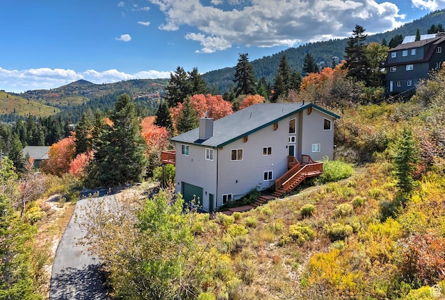 birds eye view of property with a forest view and a mountain view