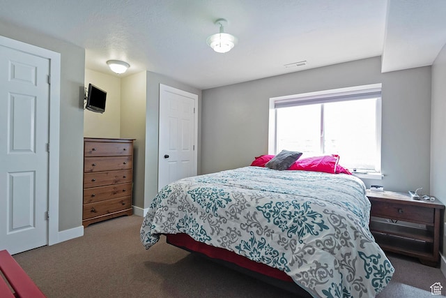 carpeted bedroom with baseboards and visible vents