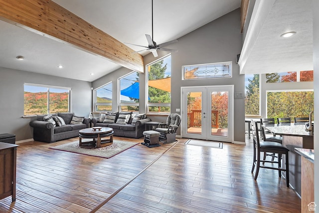 living area with french doors, recessed lighting, a ceiling fan, wood finished floors, and high vaulted ceiling