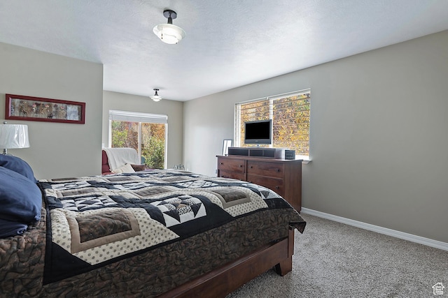 carpeted bedroom with baseboards