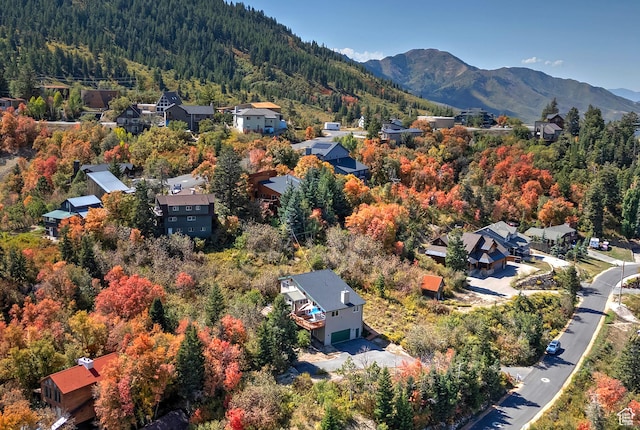 birds eye view of property with a residential view, a view of trees, and a mountain view